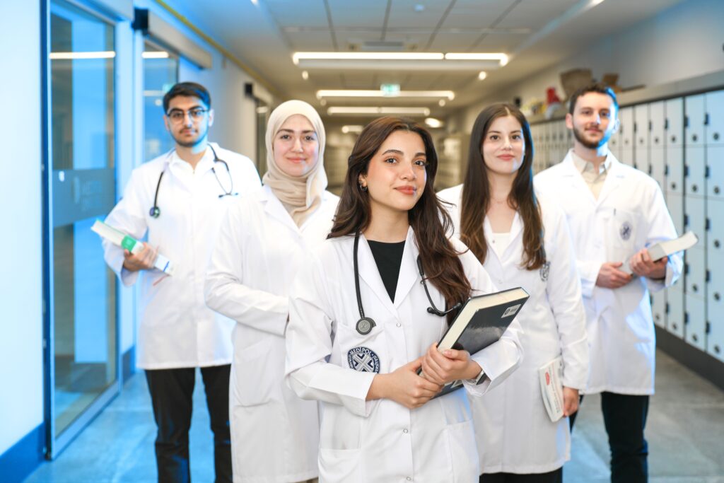 pexels photo 32213424 32213424 Group of diverse medical students wearing lab coats in university corridor, representing future healthcare professionals.